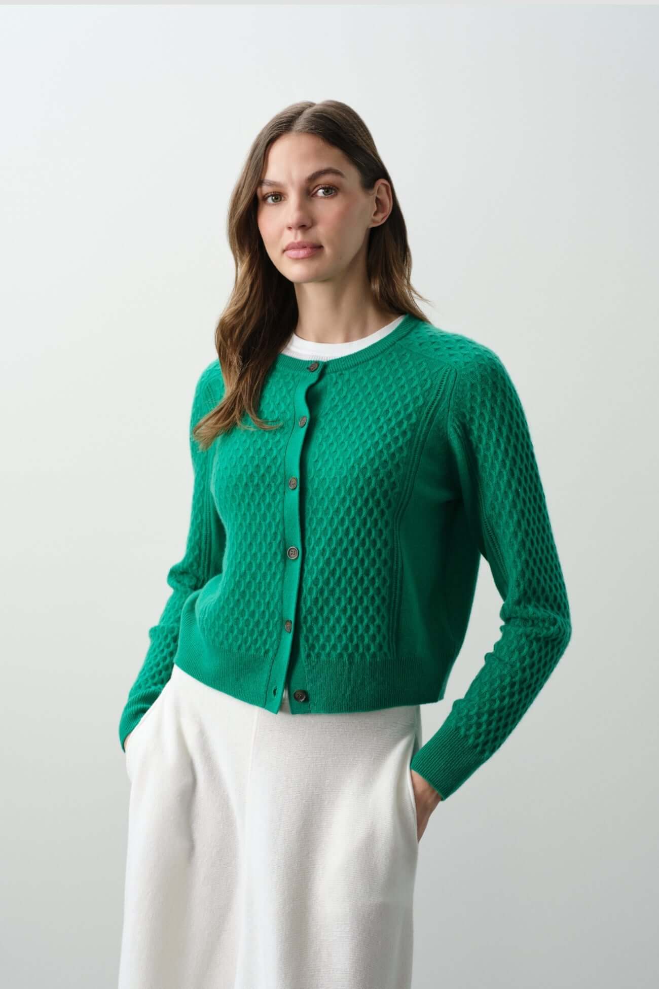 Green cardigan styled with a white skirt, perfect addition to any wardrobe. Shop our collection of Cardigans.
