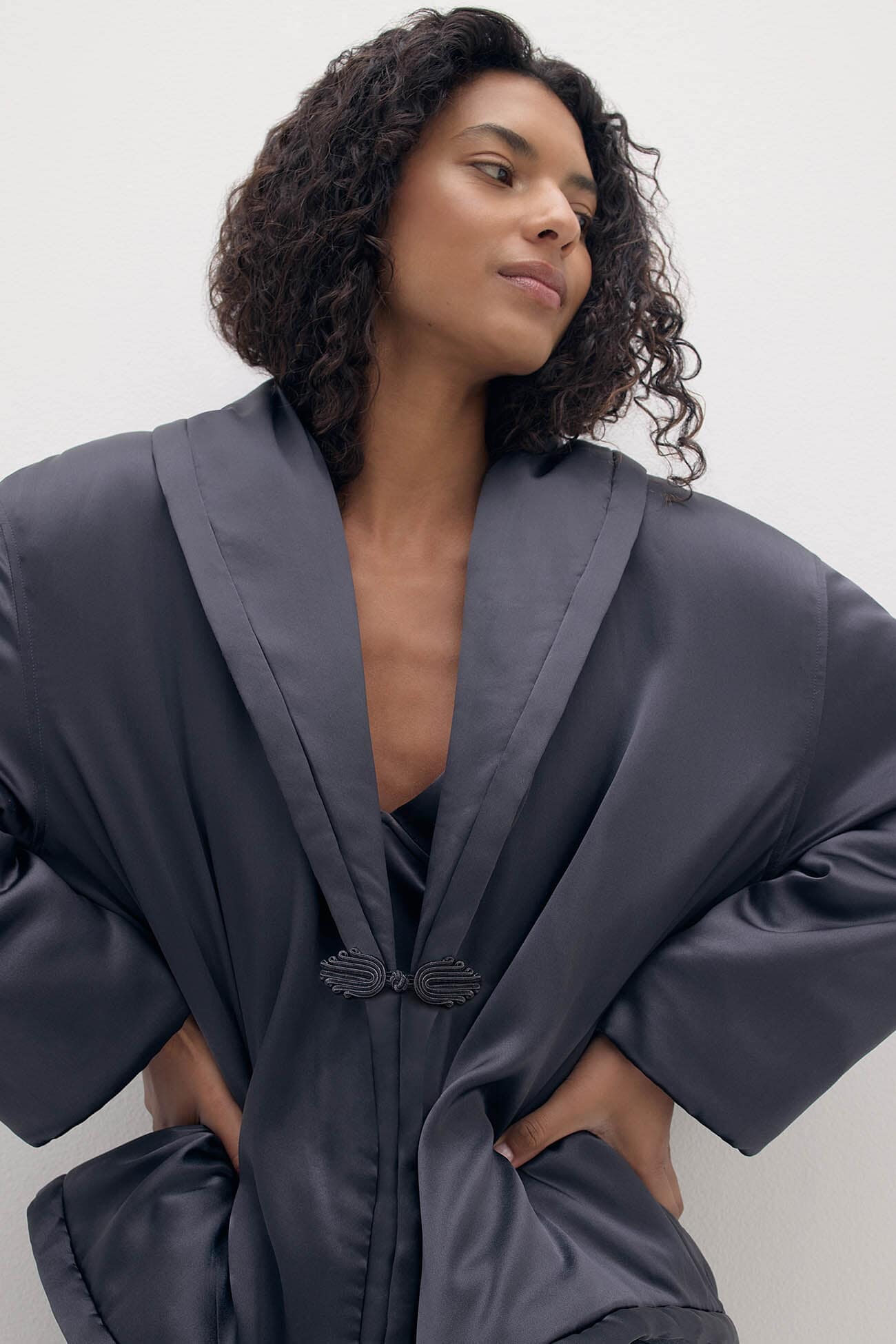 Stylish model showcasing elegant outerwear in a chic gray robe, perfect for layering this season.